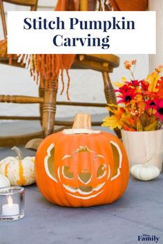 a pumpkin sitting on top of a table next to flowers