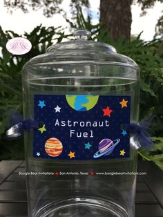 a clear jar filled with water sitting on top of a wooden table