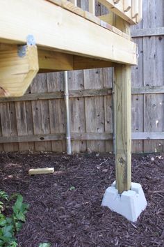 a wooden deck in the middle of some mulch