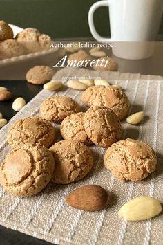 some cookies are sitting on a table next to a cup and saucer with almonds