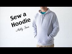 a man standing in front of a white brick wall with the words sew a hoodie on it