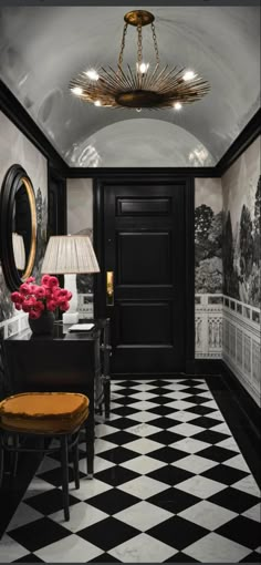 a black and white checkered floor with a chandelier