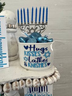 a hanukkah menorah with blue candles and chocolate candies in it