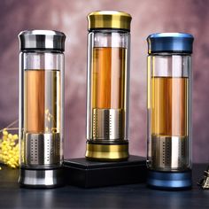 three different types of tea infustors sitting on a table next to each other