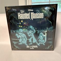 the box for the board game's animated version is shown in front of a window