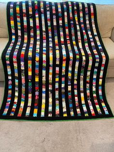 a couch with a quilt on top of it