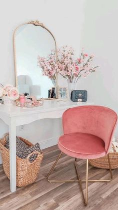 a pink chair sitting in front of a white desk with a mirror on top of it