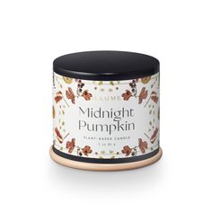 a candle that is sitting in front of a white background with the words midnight pumpkin on it