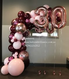 balloons and streamers in the shape of the number 30