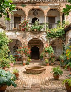 an old courtyard with potted plants and flowers