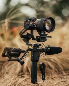 a camera attached to a tripod in a field