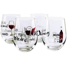 four wine glasses with different sayings and designs on the glass are lined up in a row