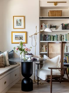 a living room filled with furniture and bookshelves