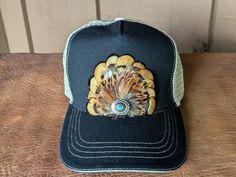 Transform your look with our Golden Trucker Hat. This versatile hat is great for music festivals, outdoor activities, and more. Channel your inner rocker and country music aficionado while staying comfortable and stylish in western fashion. It features a classic chino twill front panel and a soft tea stain mesh back panel. The antique silver Southwestern-inspired Concho with faux turquoise adds a touch of rustic charm. With a velcro closure and a comfort sweatband, it's perfect for all head sizes. Adjustable Brimmed Hat For Country Festivals, Casual Black Hat For Music Festival, Western Style Adjustable Baseball Cap With Curved Brim, Western Style Adjustable Baseball Cap For Country Events, Country Style Baseball Cap For Outdoor, Adjustable Country Style Hats For Country Festivals, Western Style Hats For Fall, One Size Fits Most, Black Snapback Hat For Summer Festival, Country Style Baseball Cap