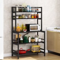 a microwave is on top of a shelf in the kitchen with dishes and utensils