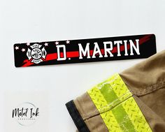 a fireman's uniform and name tag on a white background with the words d martin