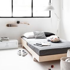 a bedroom with white walls and black windows