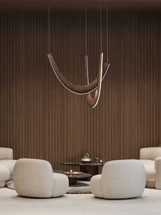 a living room filled with white furniture and a chandelier hanging from the ceiling