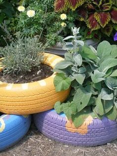 three tires are stacked on top of each other with plants growing out of them in the middle