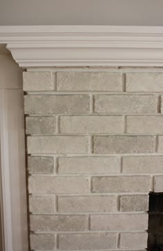 a brick fireplace with white paint on it