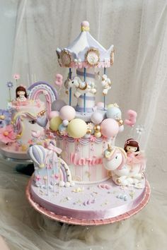 there is a cake that looks like a carousel with balloons and other decorations on it