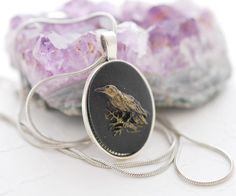 This black raven cameo necklace features a 25x18mm oval resin cameo with a highly detailed, black raven design on a black background that has been secured to an antique silver plated tray. I hand painted this particular cameo with a touch of vintage gold for an aged, vintage finish to bring out some of the finer details of the cameo and make it pretty and unique. This pendant is strung onto an antique silver plated cable chain necklace with a lobster clasp closure. The clasp and chain are lead, nickel and cadmium free and the necklace itself is very comfortable and easy to wear.  Oval pendant measures 25x18mm, necklace measures 22 inches plus a two inch extender chain. This cameo necklace will be securely wrapped and shipped for FREE any place in the United States in a kraft box perfect fo Raven Design, Silver Plated Trays, Black Raven, Necklace Gothic, Cable Chain Necklace, Gothic Necklace, Bird Necklace, Cameo Necklace, Necklace Black