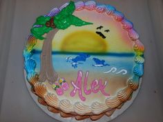 a birthday cake decorated with an image of a beach and palm tree on the side