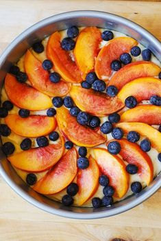 blueberries, peaches and yogurt in a metal bowl