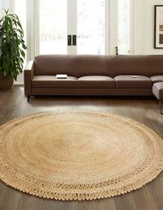 a living room with a brown couch and rug