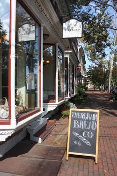 a sign is on the sidewalk in front of a storefront that says ever soak bread co