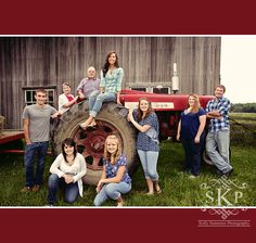 a group of people are posing in front of a tractor