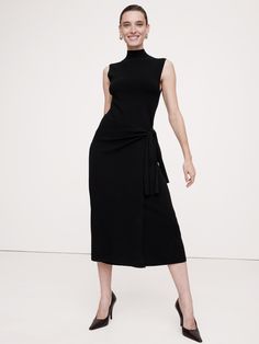 This everyday essential dress is made from a high-stretch blend of LENZING™ ECOVERO™, knitted using a half-Milano stitch to add soft structure.  Here, we opted for a streamlined, wrap silhouette with a mock neck as an ode to the season's 90s minimalism.  Semi-fitted top, straight through the waist and hip.  Sustainability: Made with LENZING™ ECOVERO™, a breathable fiber derived from certified renewable wood sources, produced using methods that reduce water impact and emissions by up to 50% compa Business Dresses Professional, Black Dress Work, Dress Work Outfit, 90s Minimalism, Wrap Sweater Dress, Essential Dress, Business Dresses, Neck Wrap, Wrap Sweater