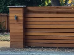 a wooden fence is shown in front of a tree