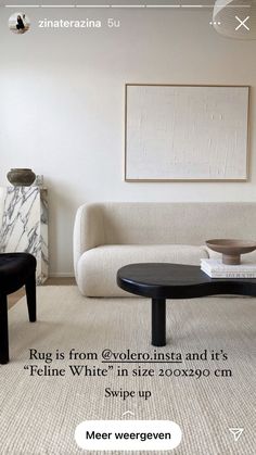 a living room with white furniture and a black coffee table