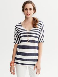 Striped Dolman-Sleeve Shirt Casual V-neck Blouse With Rolled Sleeves, Trendy Oversized V-neck Blouse, Striped V-neck Shirt For Summer, Oversized V-neck Shirt For Summer, Chic White V-neck T-shirt, Spring Striped V-neck Shirt, Trendy Short Sleeve V-neck Top For Fall, Elegant V-neck T-shirt For Summer, Trendy V-neck Relaxed Fit Blouse