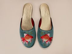 It is exotic whilst playful design with embroidery of Goldfish adding your look as eclectic as you want to be. Trust me, you will never look boring! Almond toe with padded soles for adding comfort. They are crafted from butter-soft leather lining and insole. Outsole is leather in soft brushed handfeel. Narrow fit with low heel for extra elegance. You can pair with your favorite jeans for a stroll on Sunday farmer's market, or make yourself comfy with our mules for a perfect flight outfit and jus Flight Outfit, Luxury Slippers, Mules Women, Velvet Mules, Wedding Slippers, Teal Velvet, Velvet Slippers, Special Gifts For Her, Wedding Flats