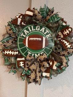 a football wreath with the words tailgate on it and a football in the center