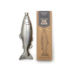 a fish shaped bottle opener next to a cardboard box