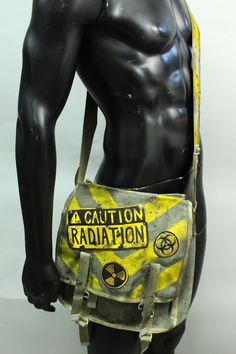 Post Apocalyptic Bag - Radiation Ammo Pouch - Military Canvas Pack - Messenger Bag - Biohazard - Patches - Larp Accessory - Yellow Stripes This listing is for a made to order bag. Please Note: The pack pictured above is representative of the style. Individual purse will vary in appearance. Simple military bag with post-apocalyptic decorations. Hand-painted stripes on the canvas and lettering + a bomb on leather patches sewn on the closure. The last photo is here to show an additional strap optio Apocalyptic Fashion, Military Bag, Estilo Punk, Character Outfits, Refashion Clothes, Post Apocalyptic, Yellow Stripes, Larp, Messenger Bags