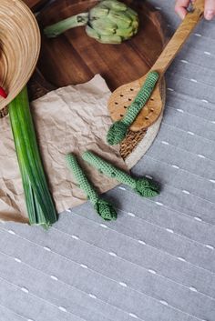 two hats and spoons on a table next to some artisanic items that are made from paper