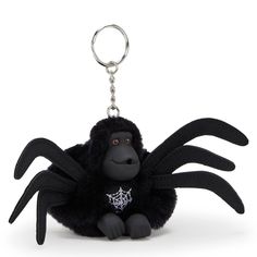 a black stuffed animal keychain with a spider on it's back