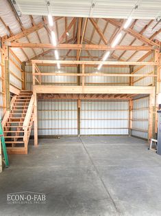 an empty garage with stairs leading up to the second floor