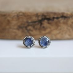 Post earrings are a staple of the jewelry wardrobe. These steely blue kyanite posts earrings are the quintessential traditional studs ...  natural, high-grade, powerful, blue kyanite stone (6mm), surrounded by finely created, oxidized, and finished .925 sterling silver ... with the perfect twist wire accent. stunning natural bluestone earrings. Blue Kyanite earrings. 6mm Blue Kyanite .925 Sterling Silver Titanium clutches.  All traditional silversmithing done in my Baltimore, MD studio. The high vibration and rapid transfers of energy from Kyanite create pathways where none existed before. Like a universal bridge, it is an extraordinary crystal of connection, opening the mind centers, enhancing telepathic and psychic abilities, bridging gaps in all communication efforts, and providing a li Kyanite Earrings, Blue Kyanite, Les Chakras, Sterling Silver Studs, Baltimore, Silver Studs, Jewelry Earrings Studs, Post Earrings, 925 Sterling Silver