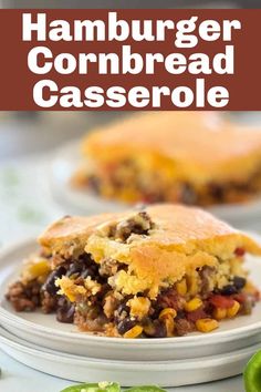 hamburger cornbread casserole on a white plate with green peppers in the background