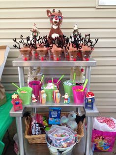 a metal cart filled with cups and candy