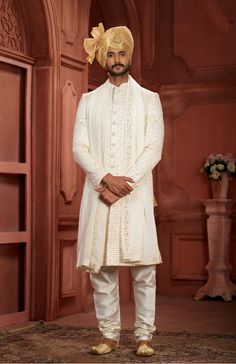 A white sherwani paired with a golden pagdi epitomizes timeless elegance and sophistication, making it a perfect choice for grooms and those attending special occasions. The white sherwani, often made from luxurious fabrics such as silk or brocade, exudes purity and grace. Its intricate embroidery, usually in gold or silver, adds a touch of regal opulence without being overly ostentatious. This combination strikes a perfect balance between tradition and modernity, making the wearer stand out wit Cream Color Wedding, White Sherwani, White Dupatta, Sherwani Groom, Sherwani For Men, Weddings Receptions, Lehenga Style, India Colors, Color Wedding