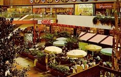 an overhead view of a shopping mall with lots of tables and umbrellas