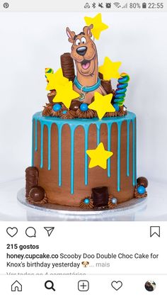 a chocolate cake with blue icing and stars on top