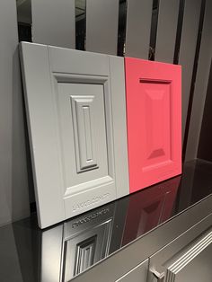 three different colored cabinets on display in a store