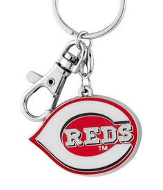 a keychain with the word reds on it and an eye shaped bottle opener